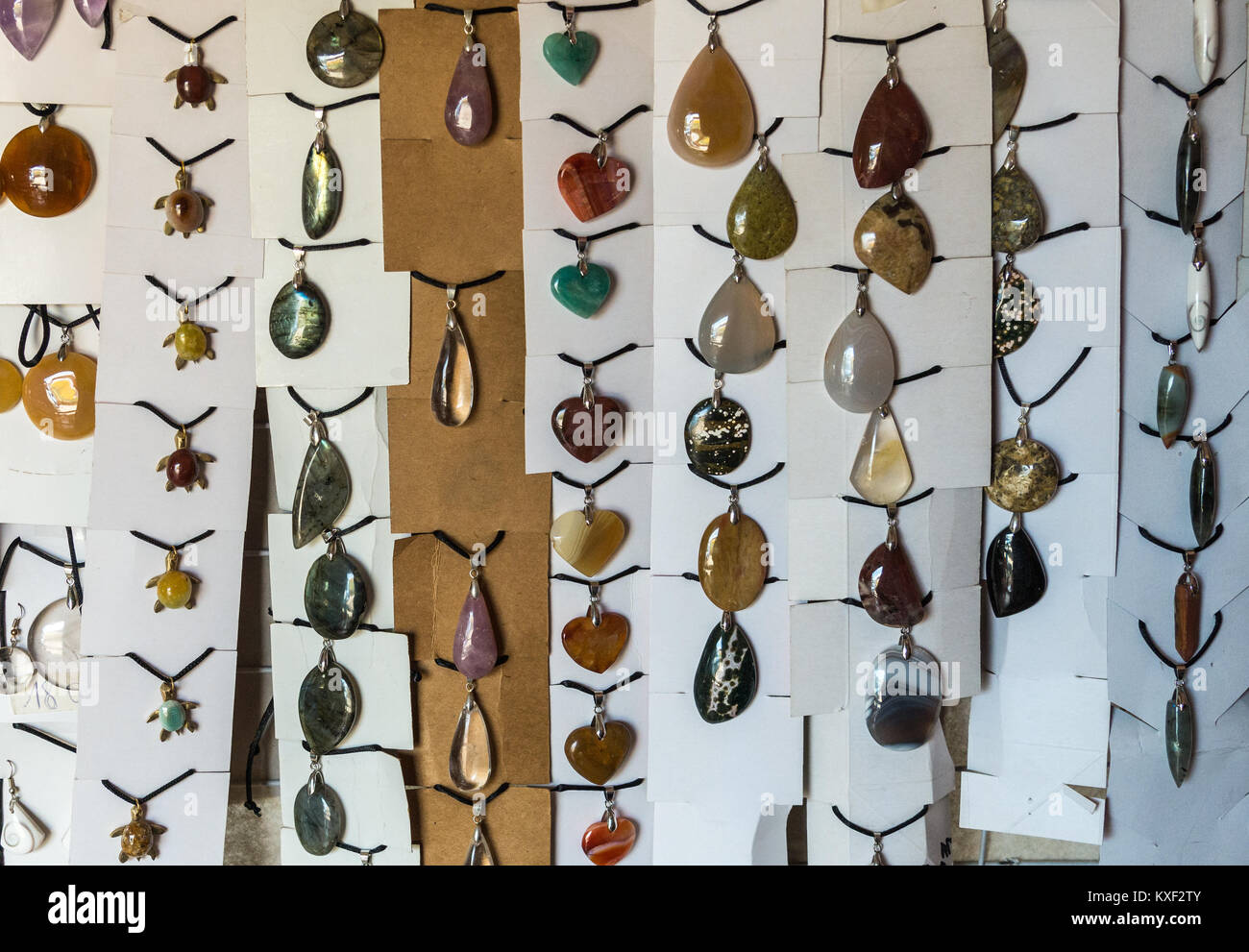 A variety of pendents made of local rocks and minerals are for sale at a souvenir store. Madagascar, Africa. Stock Photo