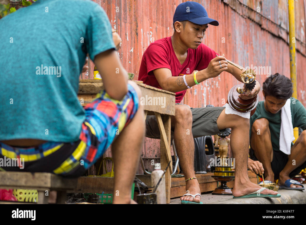 A street vendor repairing a Santo Nino Figurine in the build up to the Sinulog Festival,Cebu City,Philippines Stock Photo
