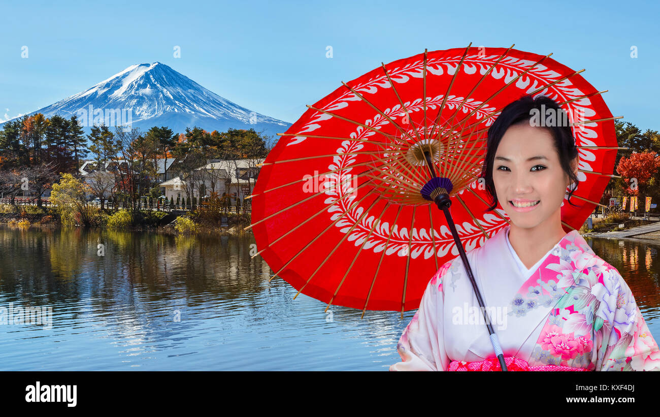 Young Japanese Woman with Mt. Fuji at Lake Kawaguchiko Stock Photo