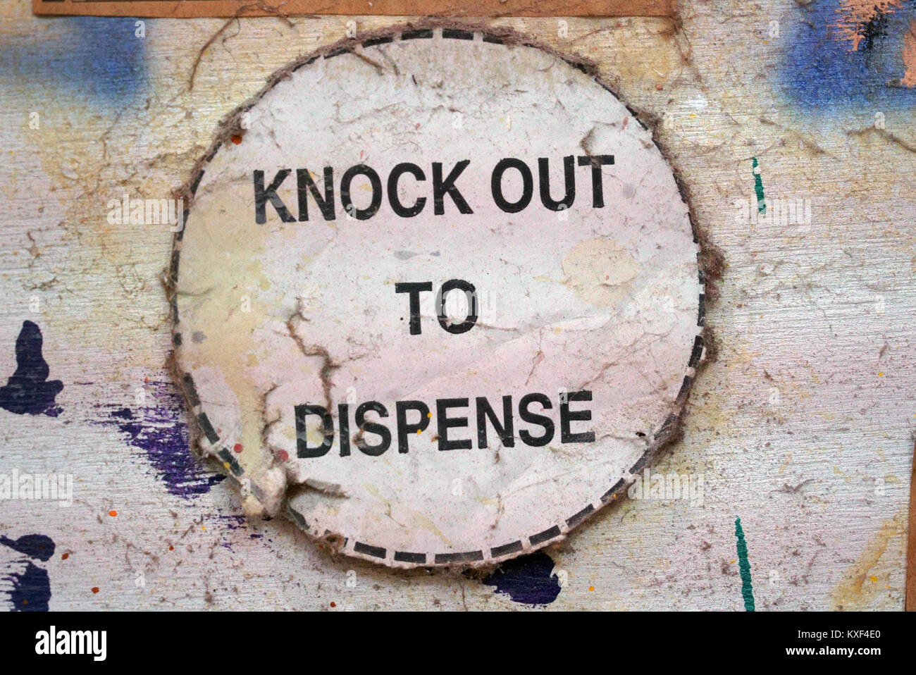 Close-up Sign: Knock out to Dispense in Circle Stock Photo