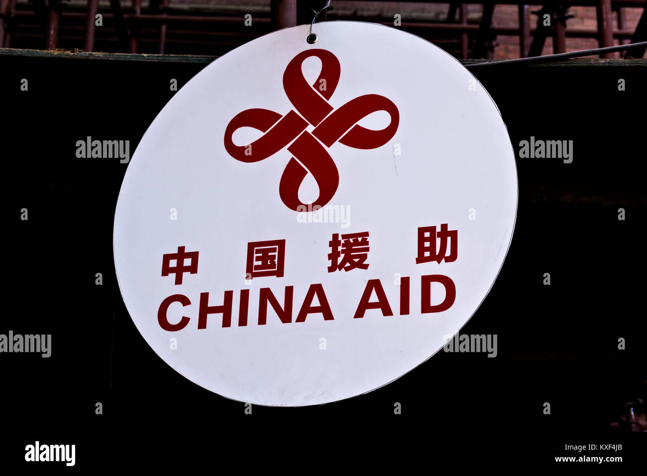 a signage saying China Aid written in english and chinese red letters on white background Stock Photo