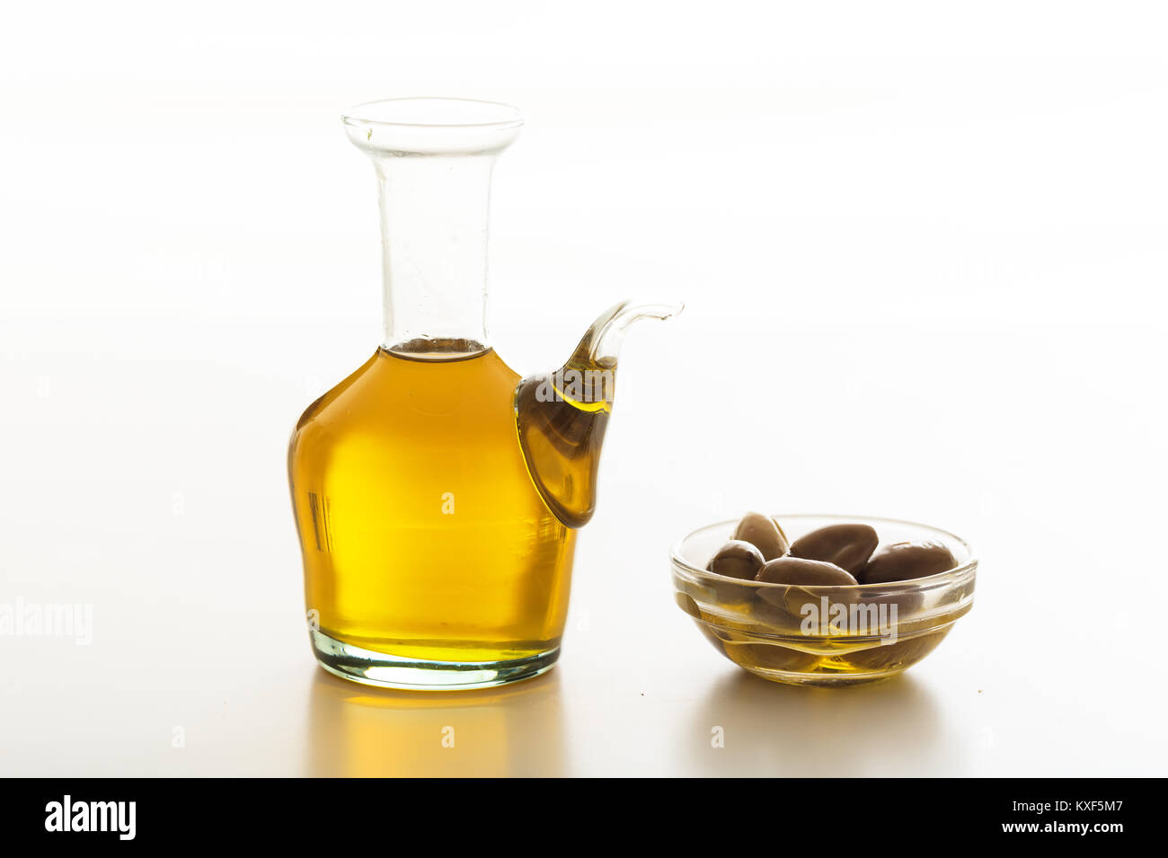 Bottle of olive oil and olives on white background Stock Photo - Alamy