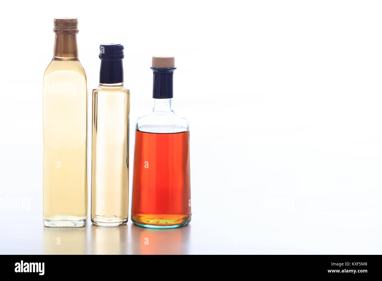 Glass bottles of vinegar on white background Stock Photo Alamy