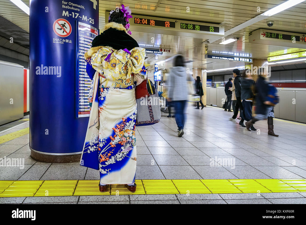 TOKYO, JAPAN - NOVEMBER 28 2015: Unidentified Japanese woman in a traditional winter Kimono dress at a subway station Stock Photo