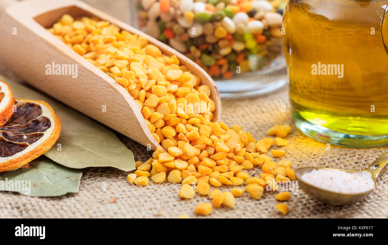 Wooden scoop with split peas on a burlappea Stock Photo