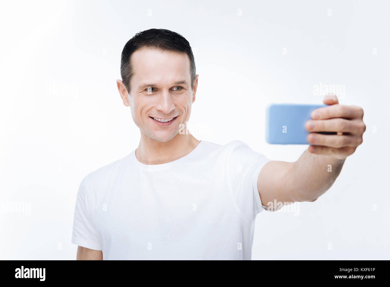 Happy delighted man taking selfie Stock Photo