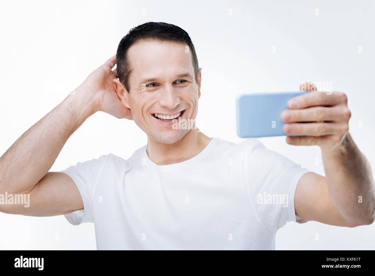 Joyful nice man posing for selfie Stock Photo