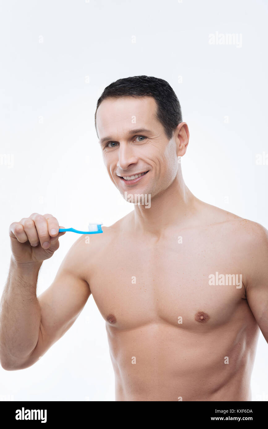 Cheerful handsome man brushing his teeth Stock Photo Alamy