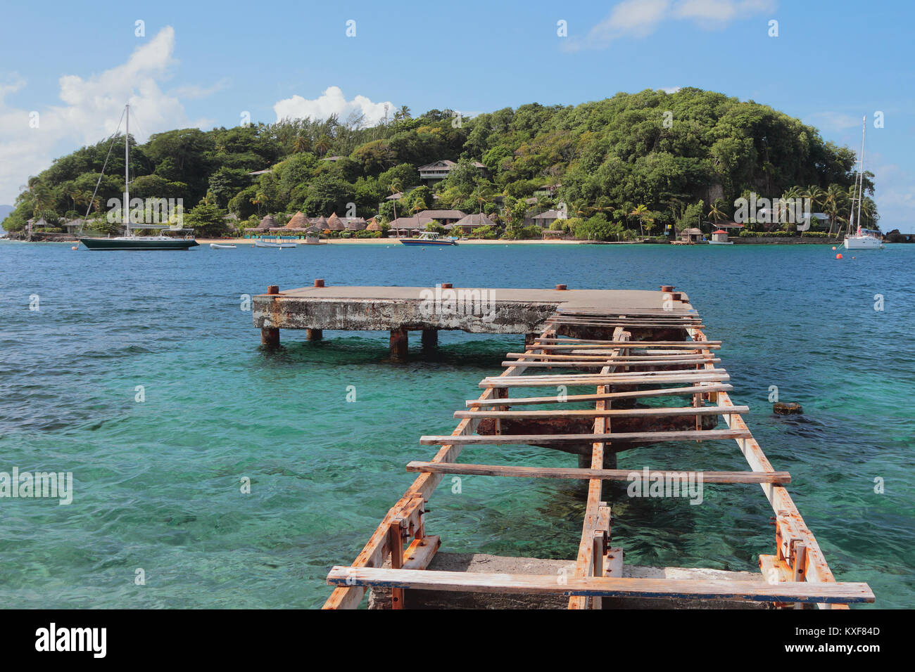 Half-ruined pier and Young Island. Kingstown, Saint-Vicent Stock Photo