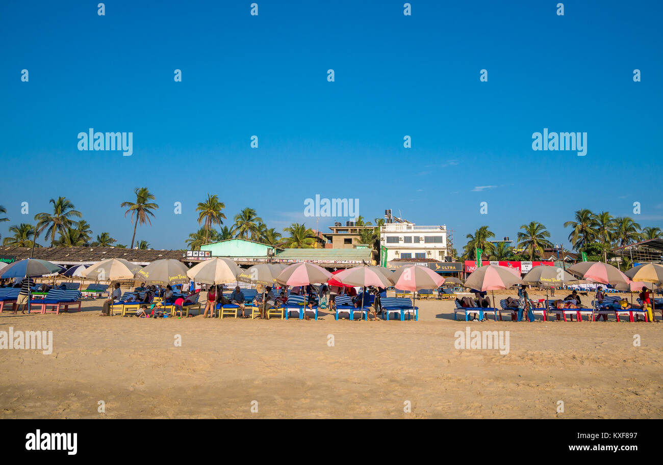 Goa, India - December, 21 2017 : Unidentified tourist relaxing using Beach beds and umbrellas to relax at North Goa beach called Baga Beach Stock Photo