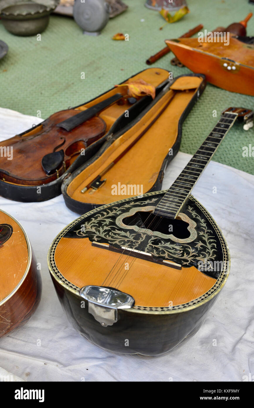 Stringed musical instruments, bouzouki, violin on sale in street flea market, Athens, Greece Stock Photo