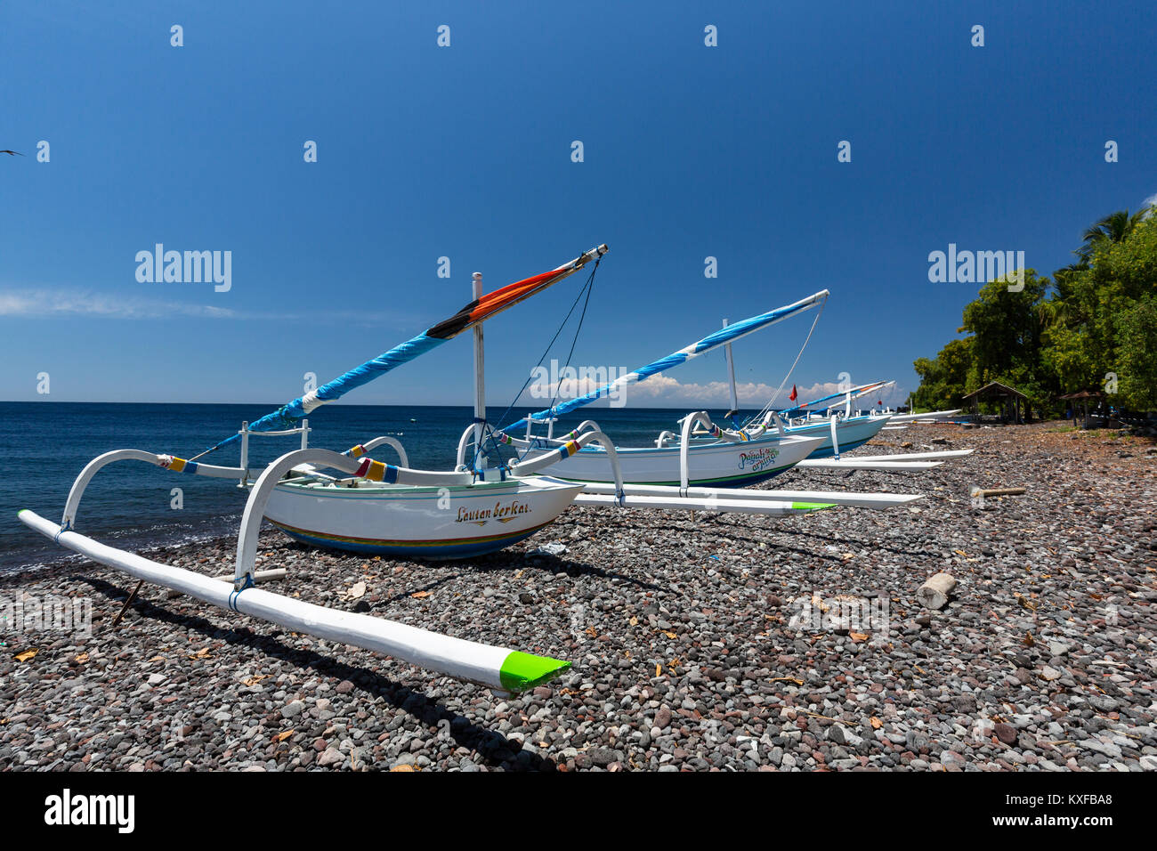 Jukong boats rest on the shoreline in Tulamben, Bali, Indonesia. Stock Photo