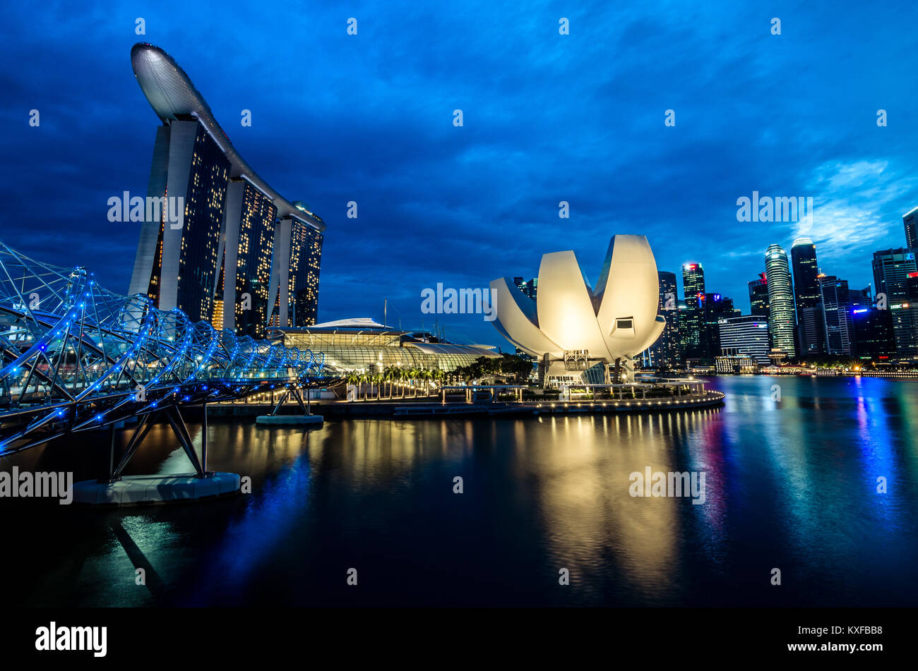 A beautiful blue hour at Marina Bay with Marina Bay Sands Hotel at the background, one of the most spectacular Hotel in Singapore. Stock Photo