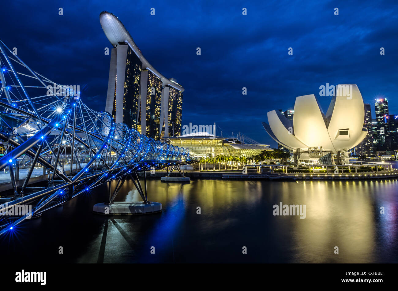 A beautiful blue hour at Marina Bay with Marina Bay Sands Hotel at the background, one of the most spectacular Hotel in Singapore. Stock Photo