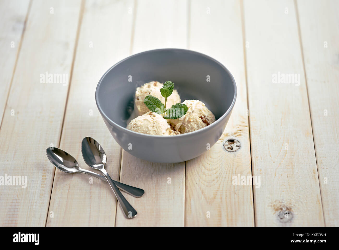 Vanilla ice cream in blue bowl Stock Photo - Alamy