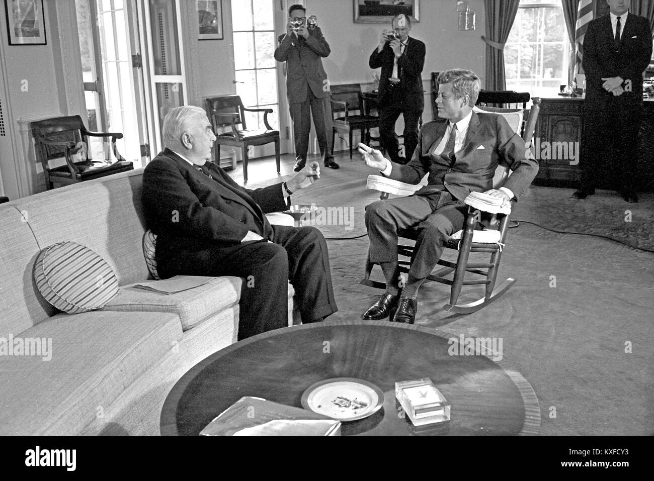 United States President John F. Kennedy (in rocking chair), right, meets with Prime Minister of Australia Robert G. Menzies, left, in the Oval Office of the White House in Washington, DC on September 25, 1962. Credit: Arnie Sachs / CNP /MediaPunch Stock Photo