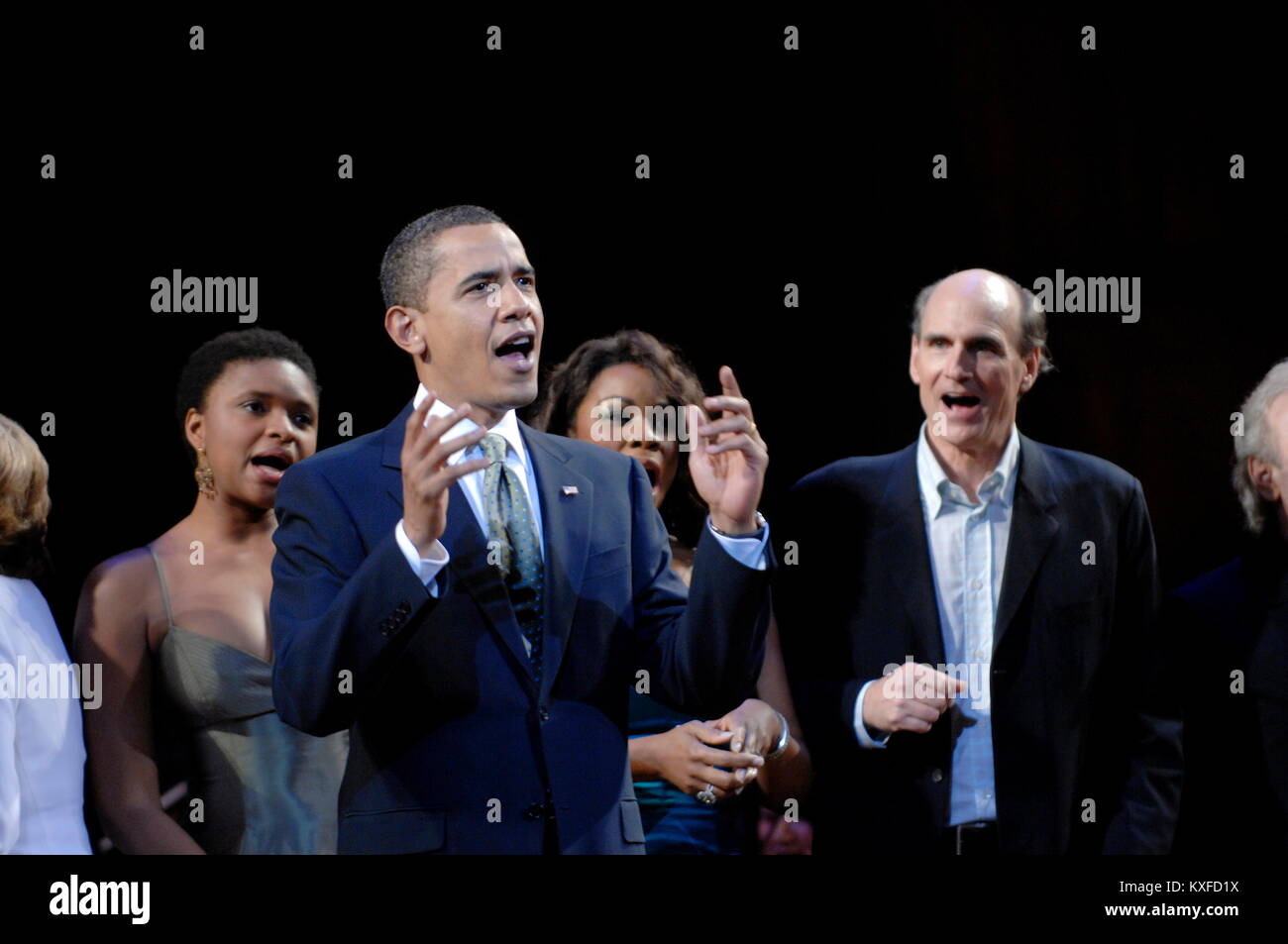 Washington, DC - March 8, 2009 -- United States President Barack Obama (C) joins performers (including James Taylor (R)) on stage to lead in singing 'Happy Birthday' to Senator Ted Kennedy (Democrat- Massachusetts)  at a musical tribute to celebrate Kennedy's birthday at the Kennedy Center in Washington, DC., USA, on Sunday, 08 March 2009..Credit: Chris Usher - Pool via CNP /MediaPunch Stock Photo