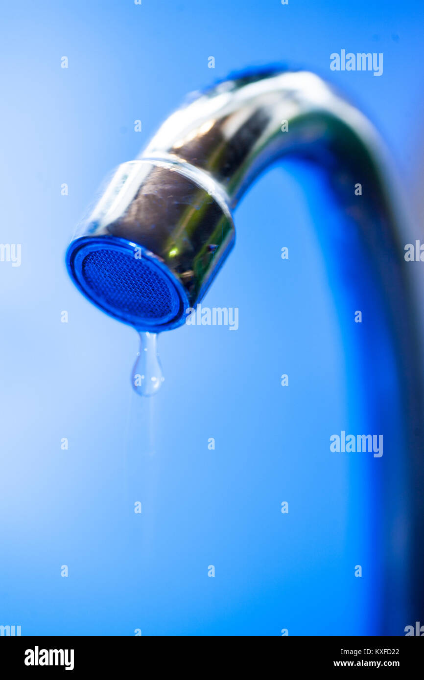 A stream of clean water flows into the stainless steel sink in blue