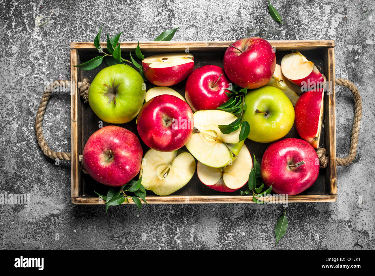 Red and green apples in a wooden tray. On a rustic background Stock ...