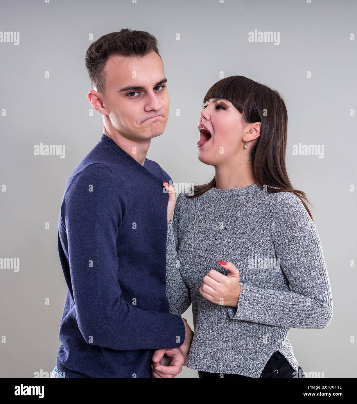 Teenage couple having an argument, studio shot Stock Photo