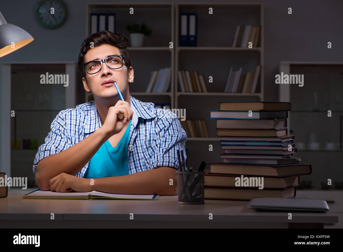 Student preparing for exams late night at home Stock Photo - Alamy