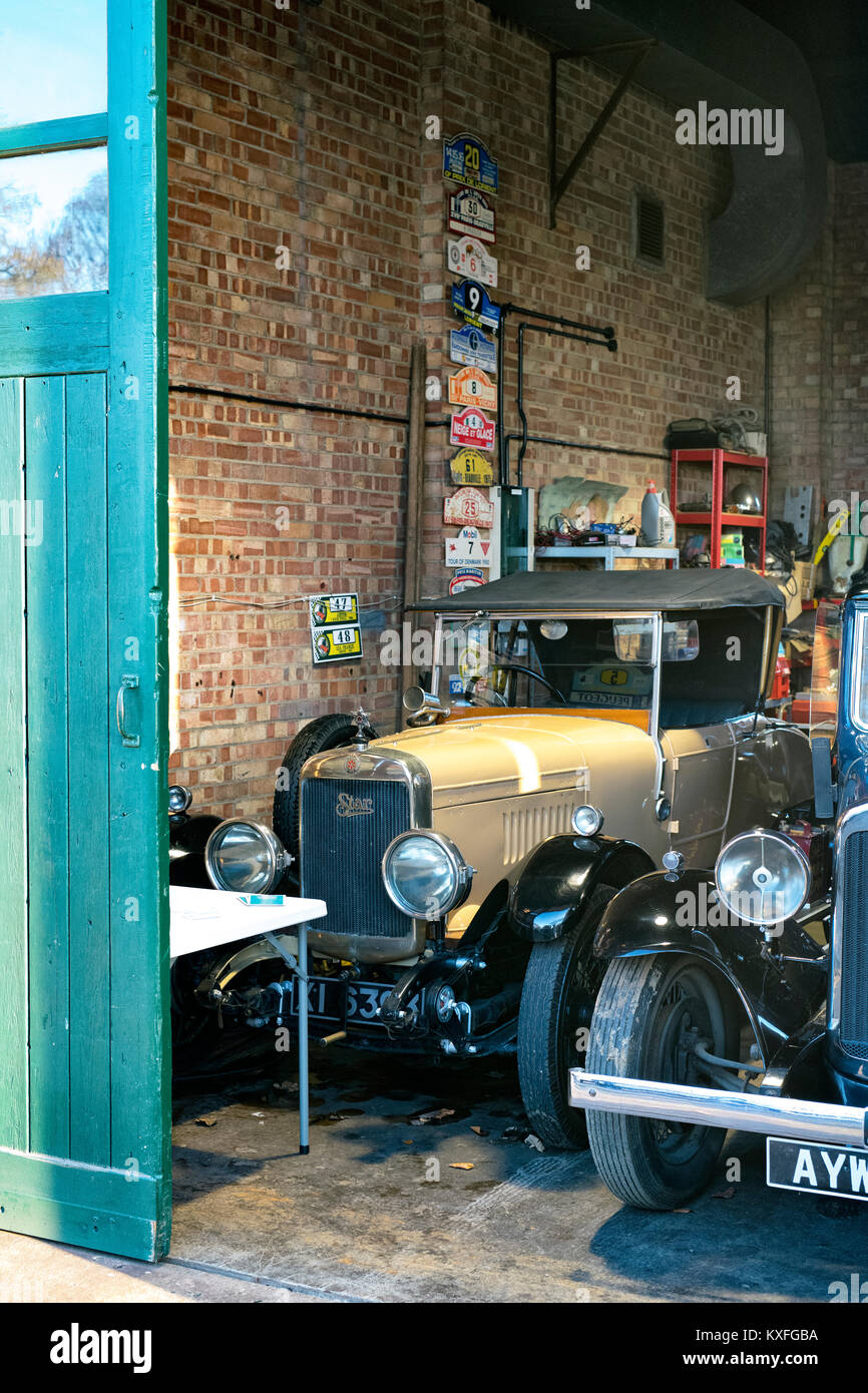 Vintage cars including a 1926 Star car in a garage at Bicester Heritage centre. Bicester, Oxfordshire, England. Stock Photo