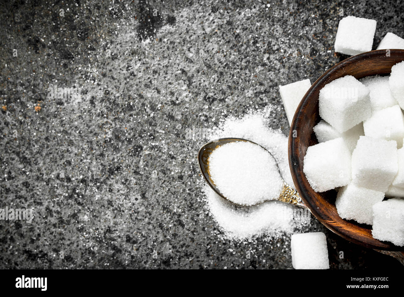 Sugar in a teaspoon. On a rustic background Stock Photo Alamy