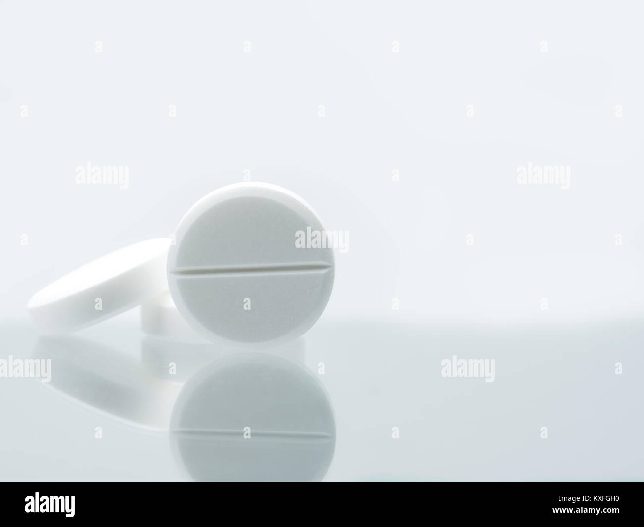 Macro shot of three white chewable tablets on white background with ...