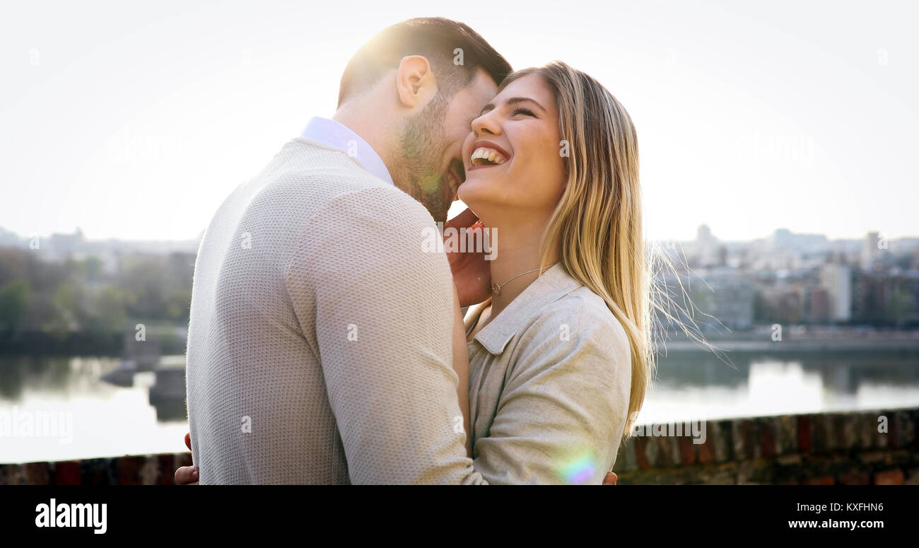 Couple kissing dating on bridge Stock Photo - Alamy