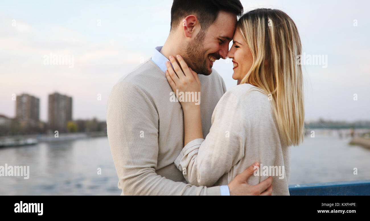 Couple kissing dating on bridge Stock Photo - Alamy