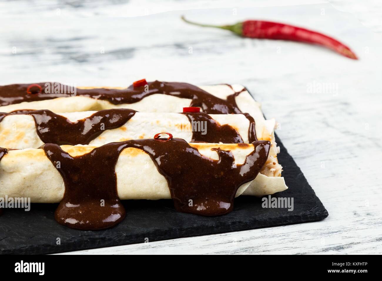 Mexican chicken enchiladas with chili chocolate salsa mole poblano