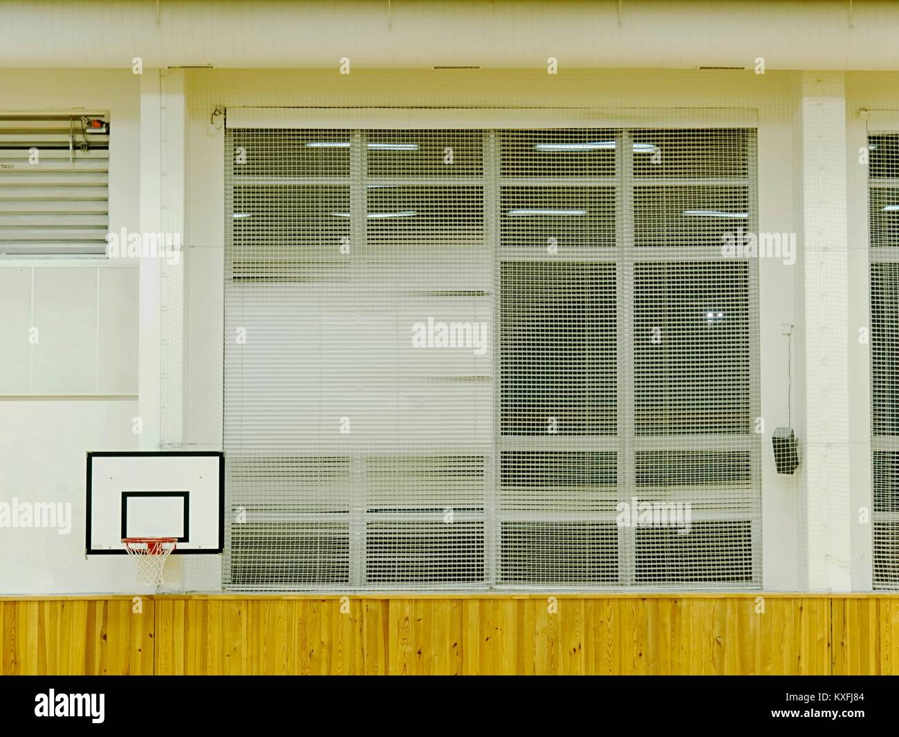 Image showcasing Interior of school gym with walls covered by safety net. Large hall ...