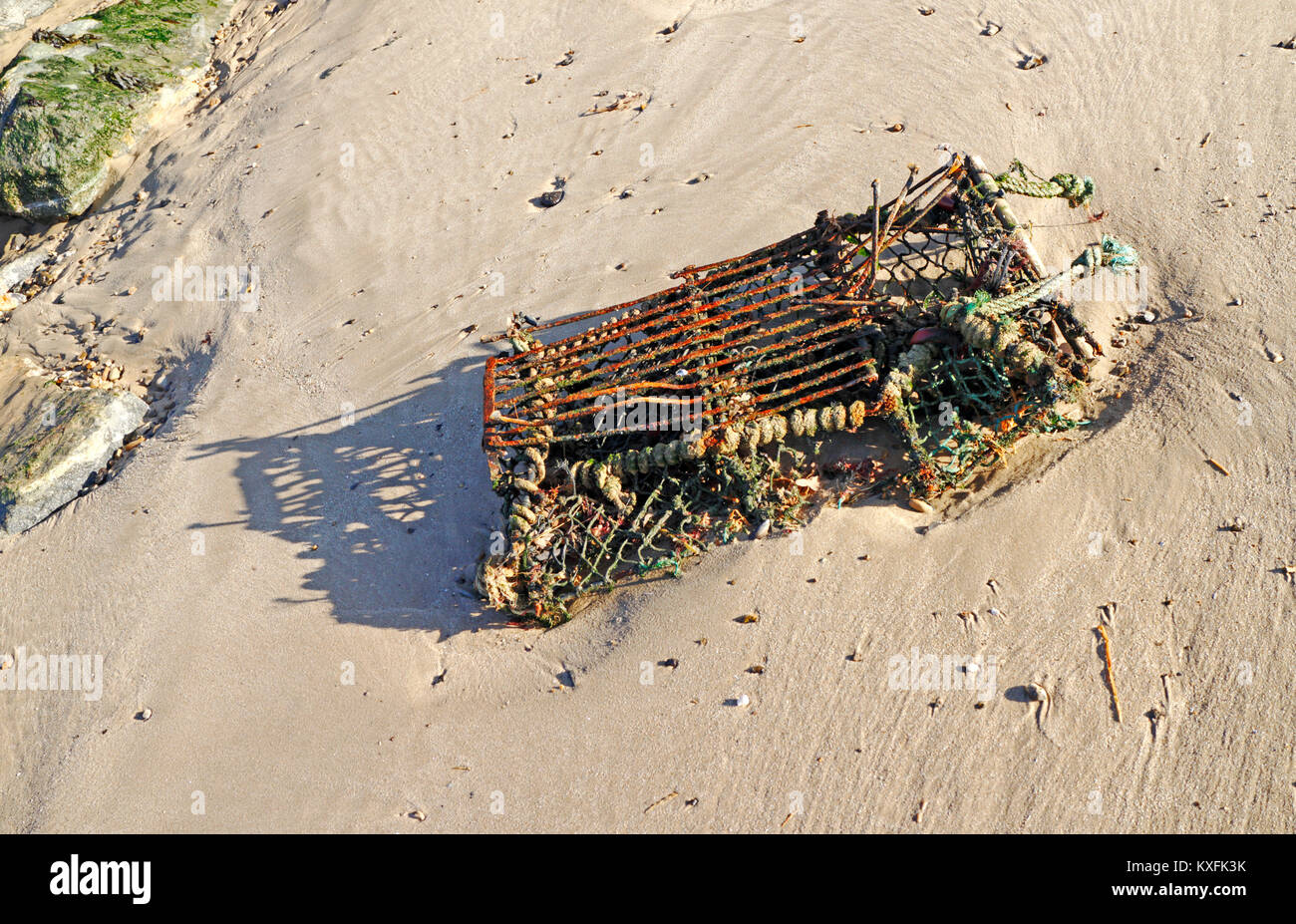 An old crab pot washed up on a beach in Norfolk, England, United Kingdom. Stock Photo
