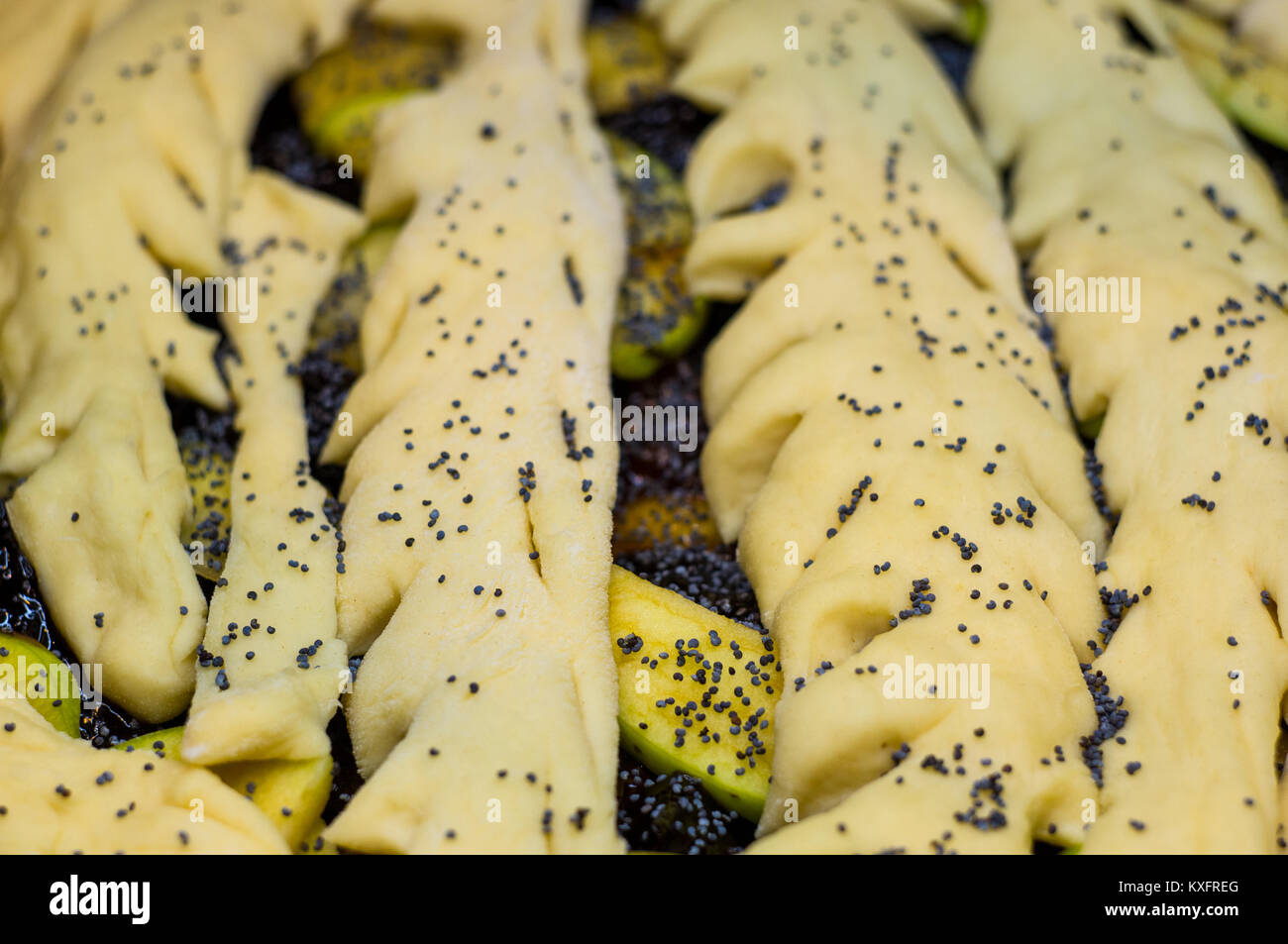 raw homemade rustic pie with apples, poppy seeds and jam, close-up ...