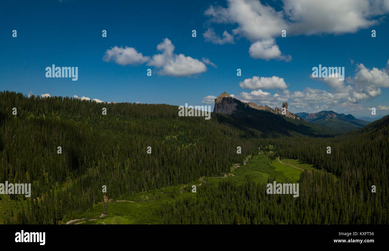 West Fork Cimarron River leads to Chimney Rock and Courthouse Mountain Panorama Stock Photo
