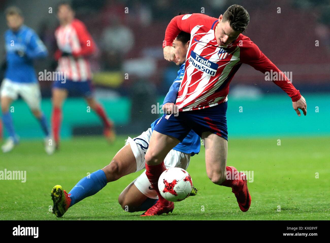 Madrid, Spain. 9th Jan, 2018. Lleida's Cheng Hui (L) and Atletico Madrid's Gameiro compete during the Spanish King's Cup round of 16 second leg match between Atletico Madrid and Lleida in Madrid, Spain, on Jan. 9, 2018. Atletico Madrid defeated Lleida with 3-0 and advanced to the quarterfinal with 7-0 on aggregate. Credit: Juan Carlos Rojas/Xinhua/Alamy Live News Stock Photo