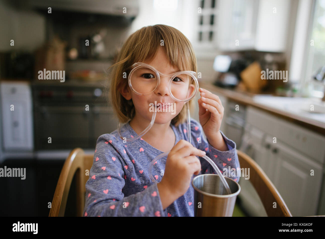 Portrait of cute girl wearing novelty glasses at home Stock Photo