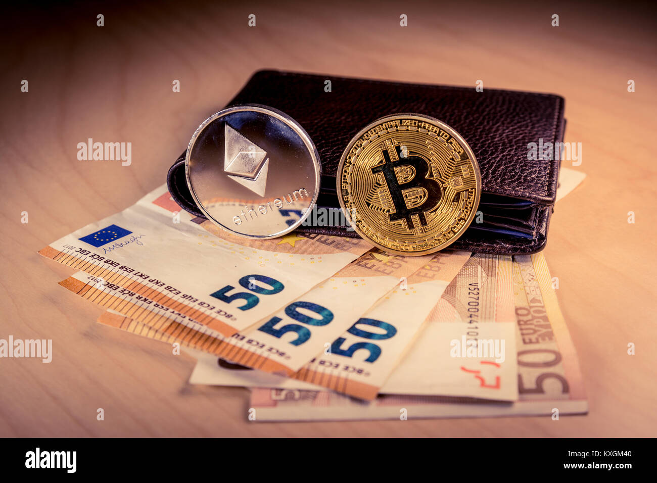 Financial concept with physical bitcoin and ethereum and Euro, Dollar bills  on a wooden table Stock Photo - Alamy