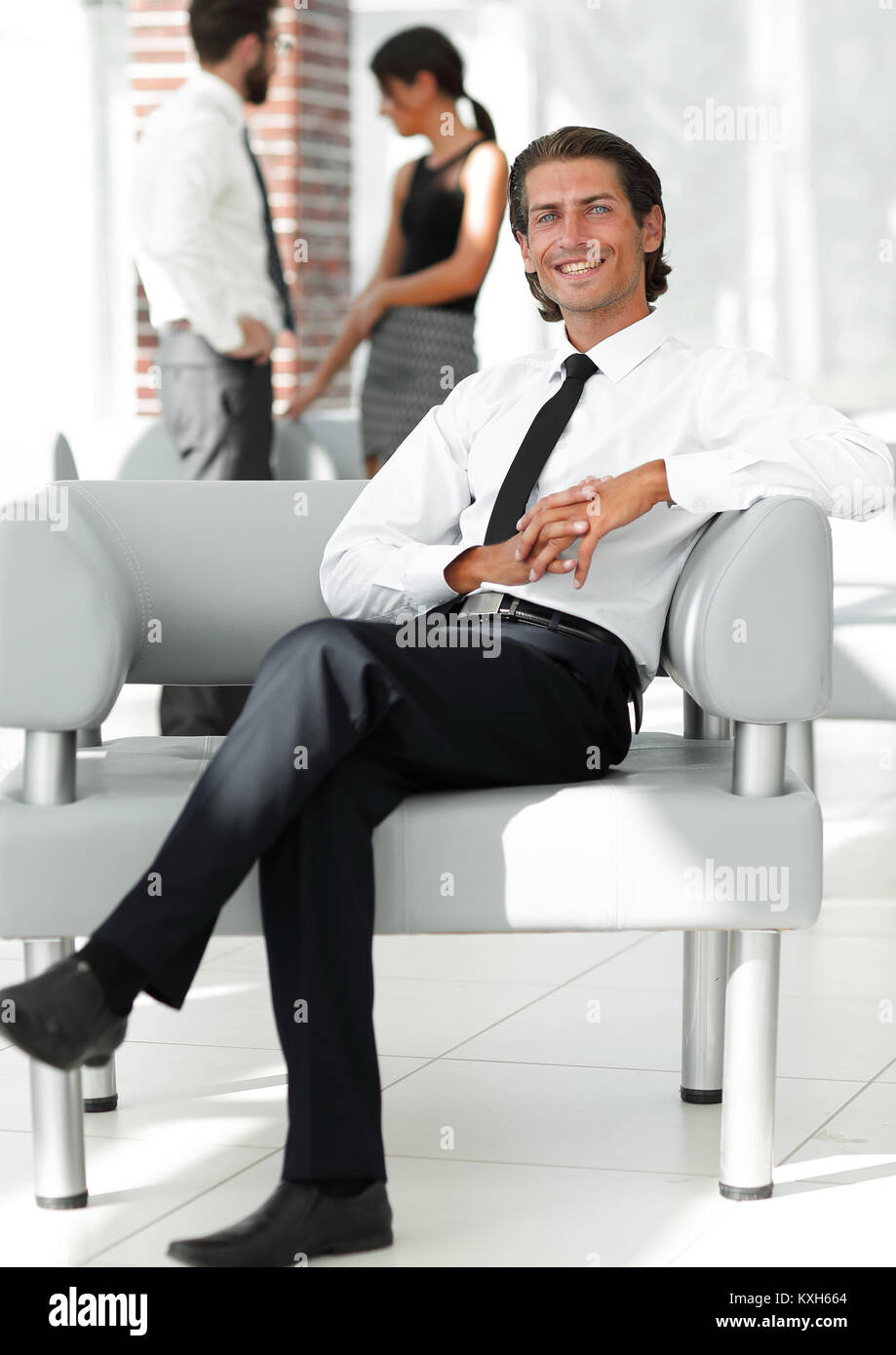 smiling businessman sitting in office chair Stock Photo - Alamy