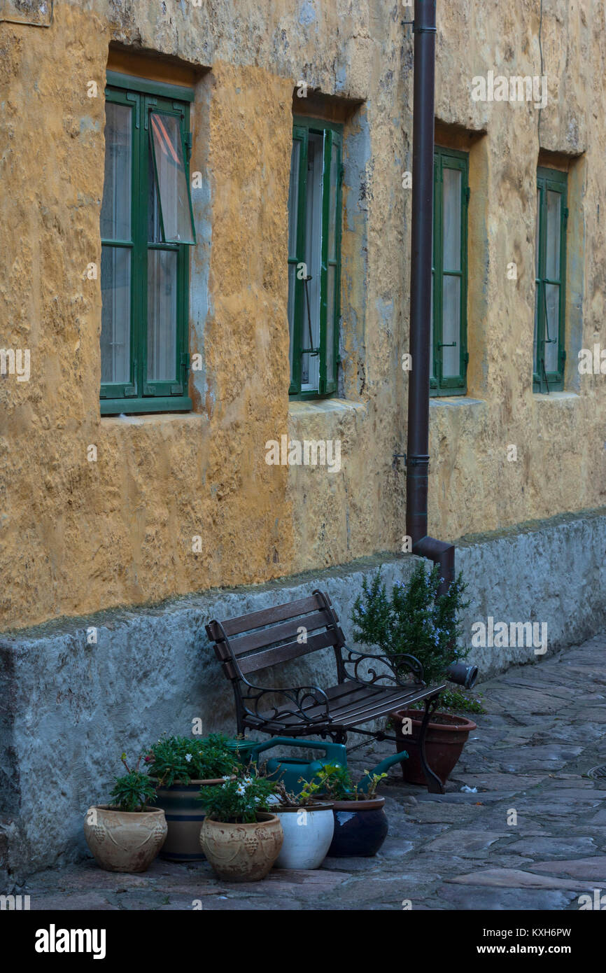 Bench, Flower pots, Downpipes, Windows in The Street (Gaden) on Christiansø, Ertholmene, Bornholm, Denmark Stock Photo