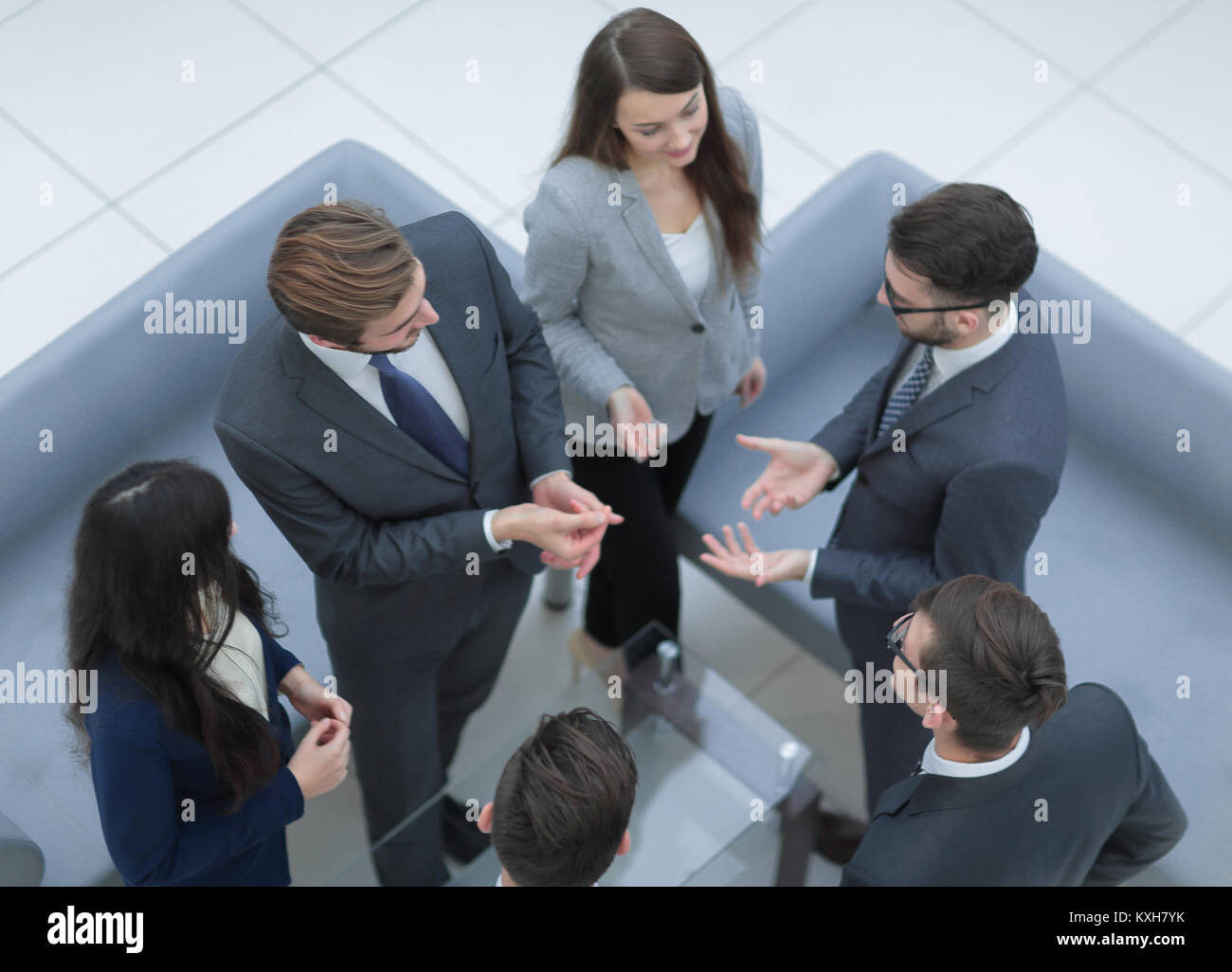 Happy smiling business team standing in a row at office Stock Photo - Alamy