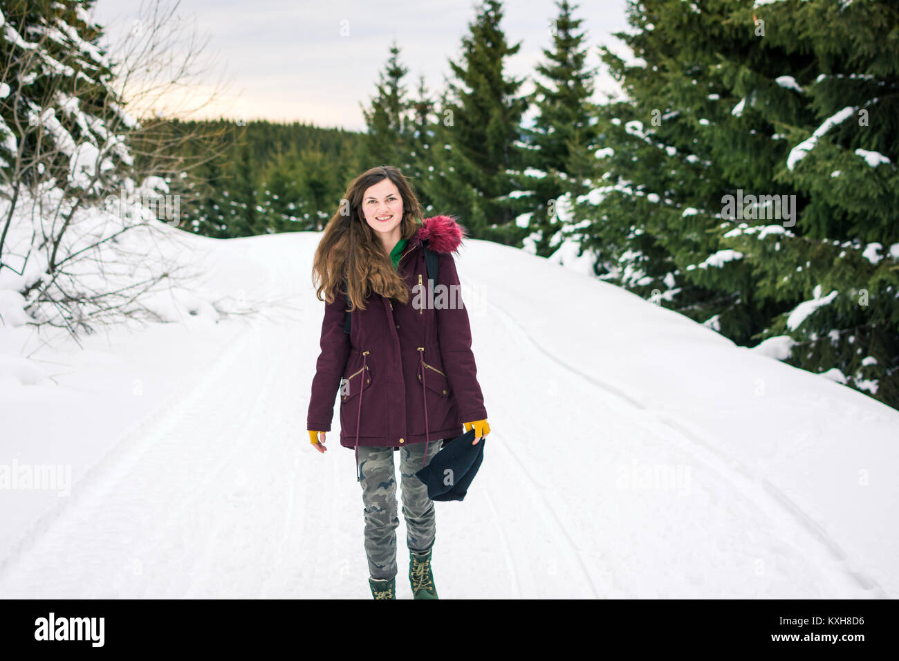 Happy Hipster girl walking on the snowy mountain Stock Photo