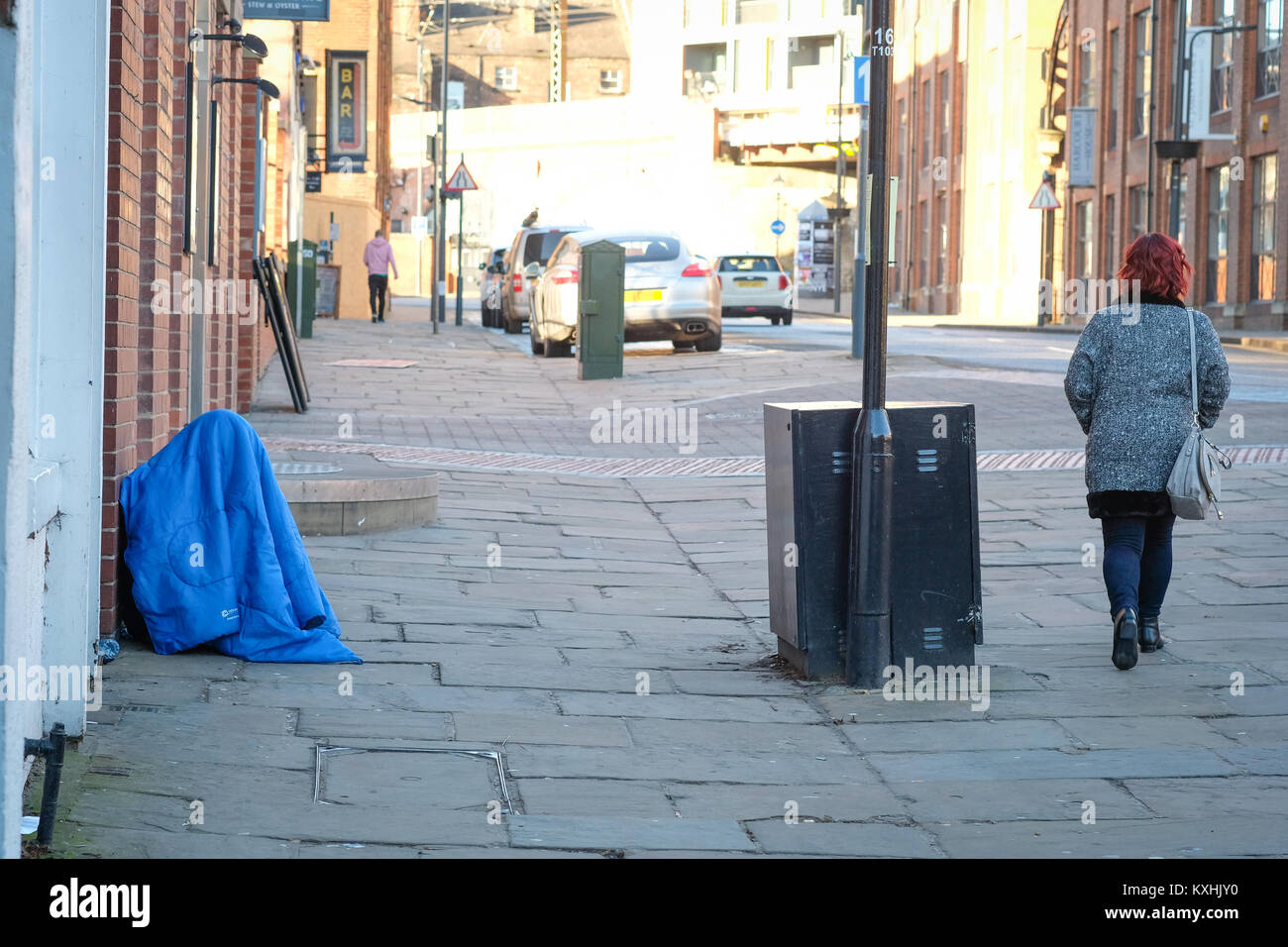 Homeless person in sleeping bag in freezing temperatures, The Calls
