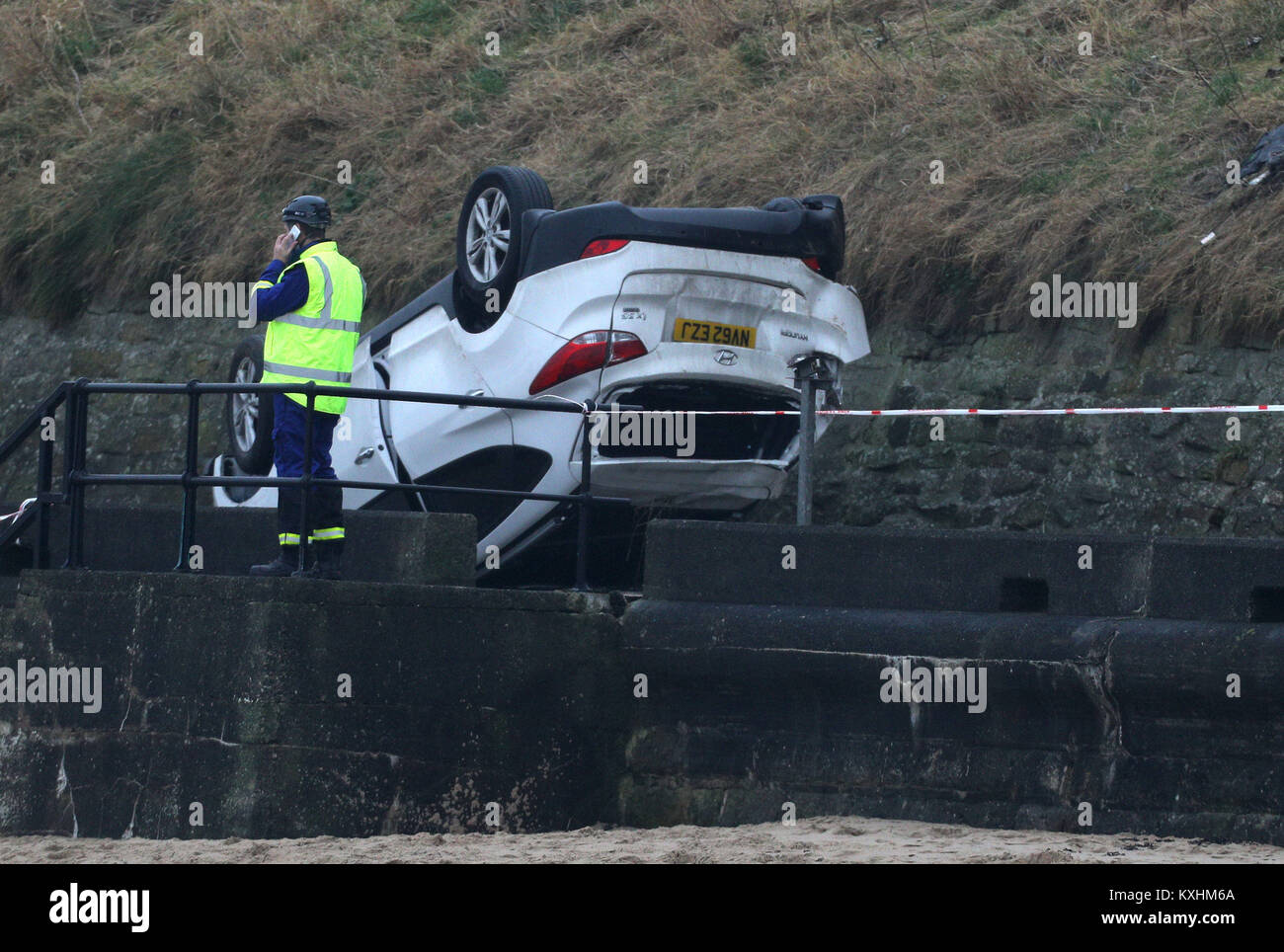 A car which has fallen off a cliff onto The Promenade in front of Tynemouth Longsands beach opposite the Grand Hotel. Stock Photo