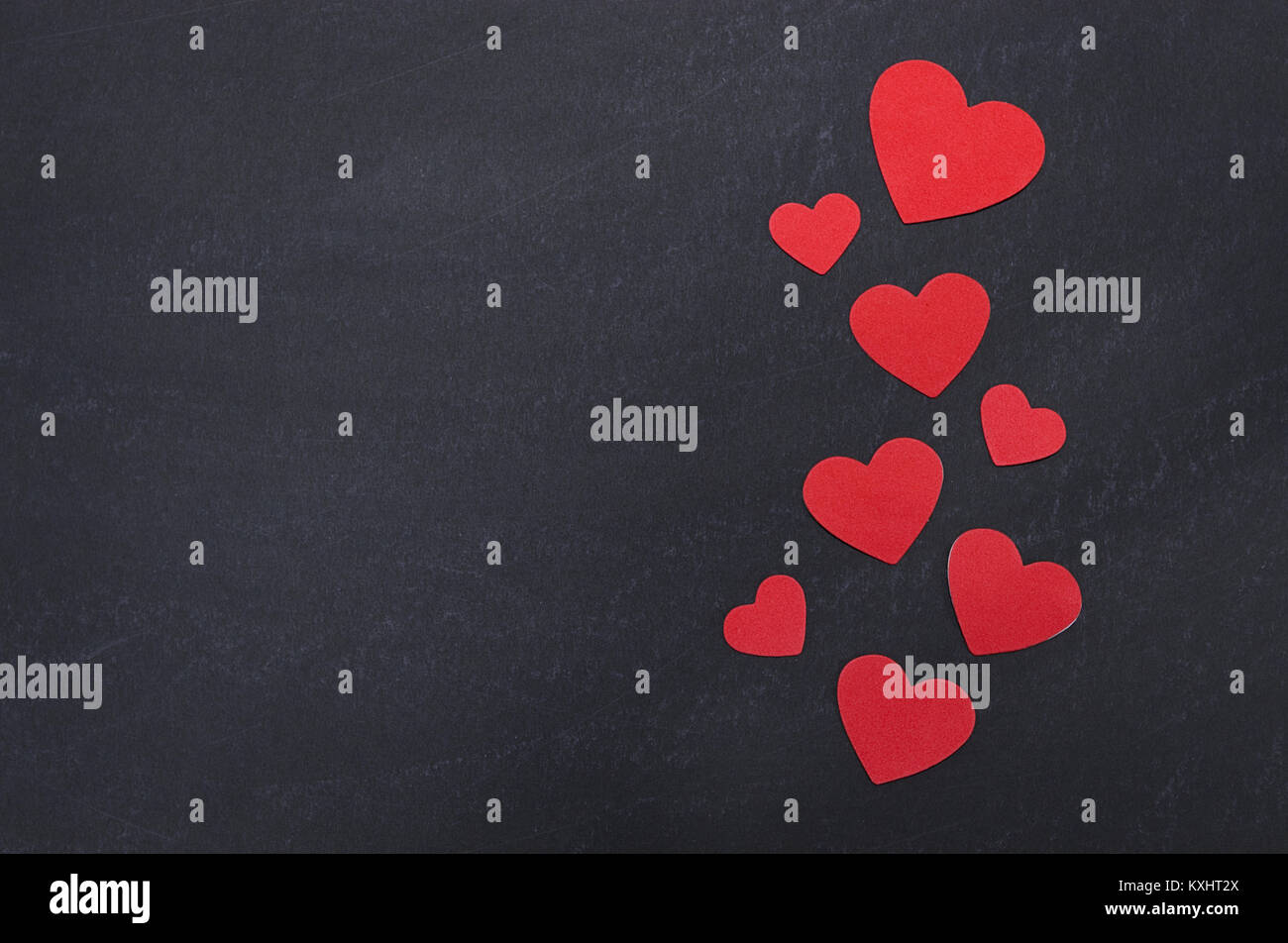 Scattered red heart border on chalkboard Stock Photo