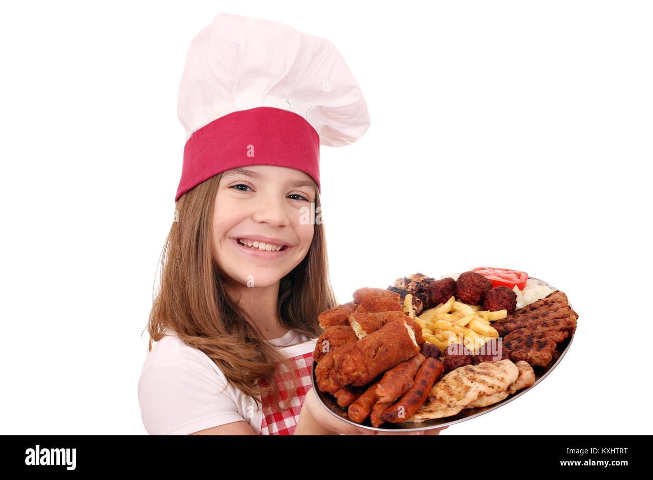 Happy little girl cook with grilled meat and salad on plate Stock Photo