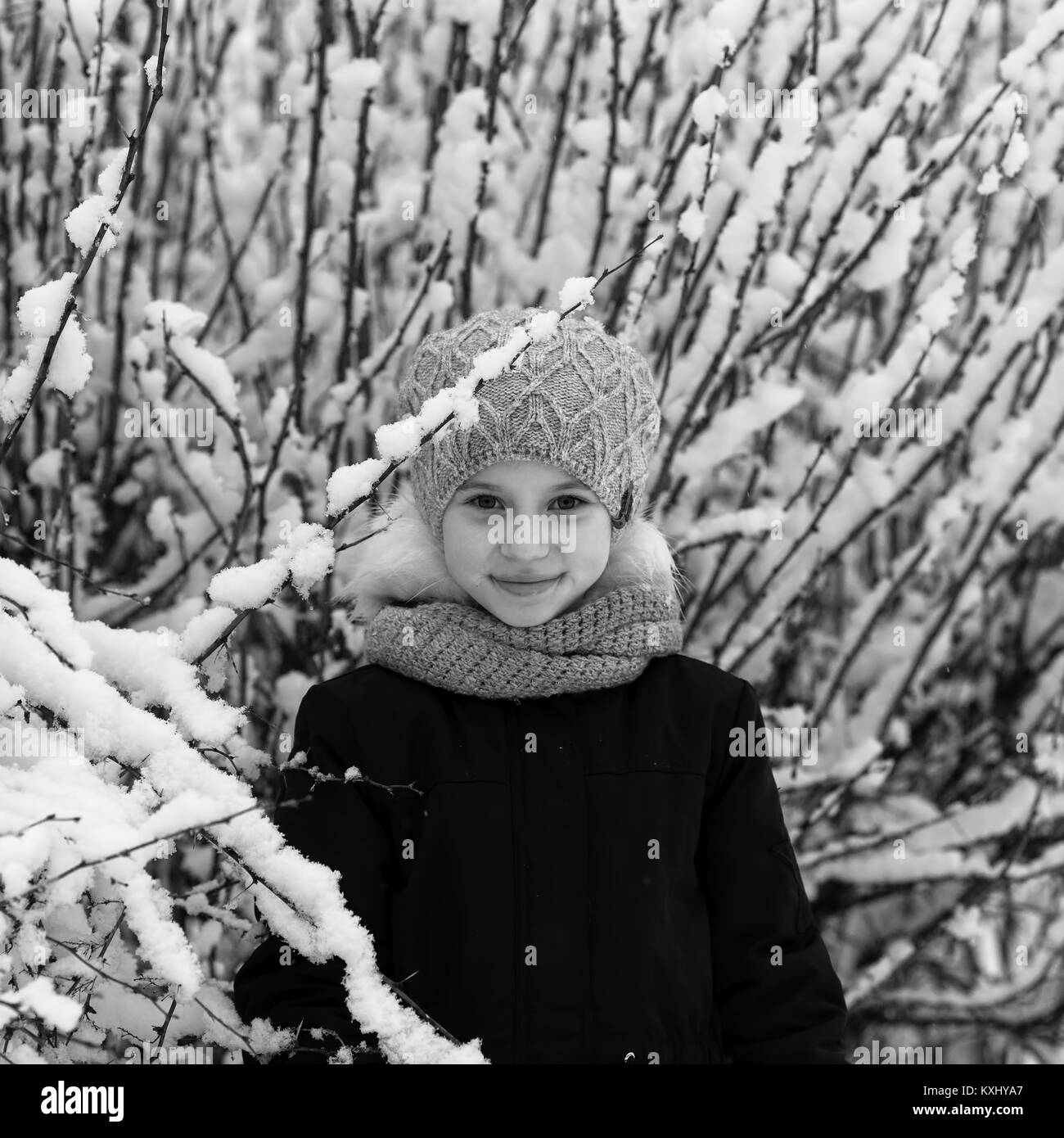 Little girl in winter snow Park, black-and-white photo. Stock Photo
