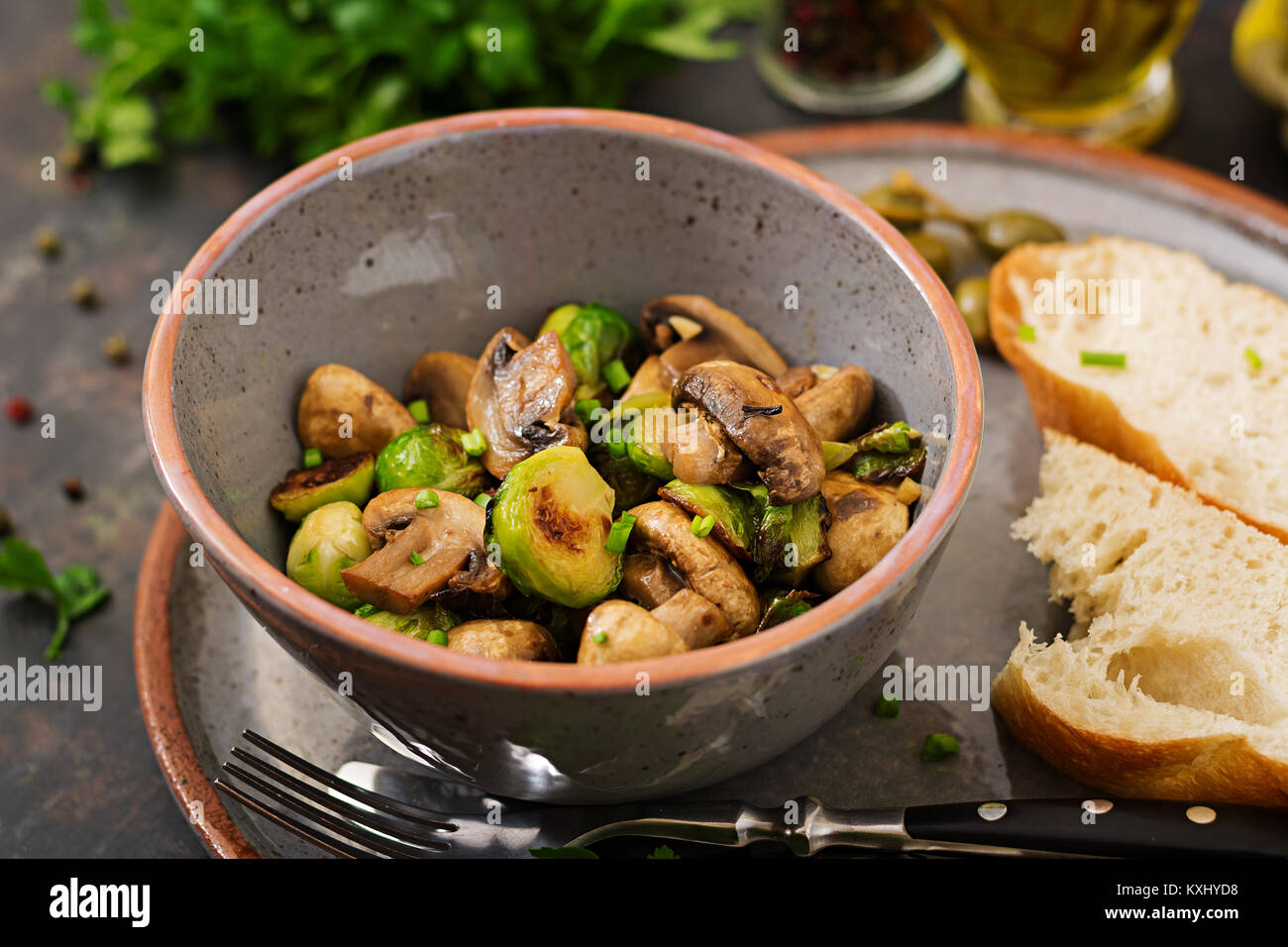 Vegan dish. Baked mushrooms with Brussels sprouts and herbs. Proper nutrition. Healthy lifestyle Stock Photo