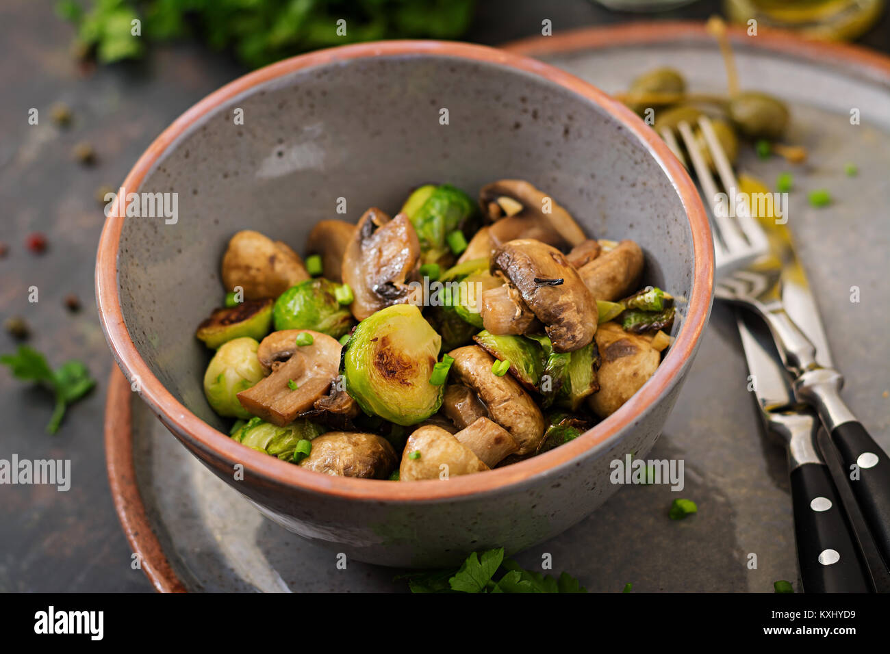 Vegan dish. Baked mushrooms with Brussels sprouts and herbs. Proper nutrition. Healthy lifestyle Stock Photo