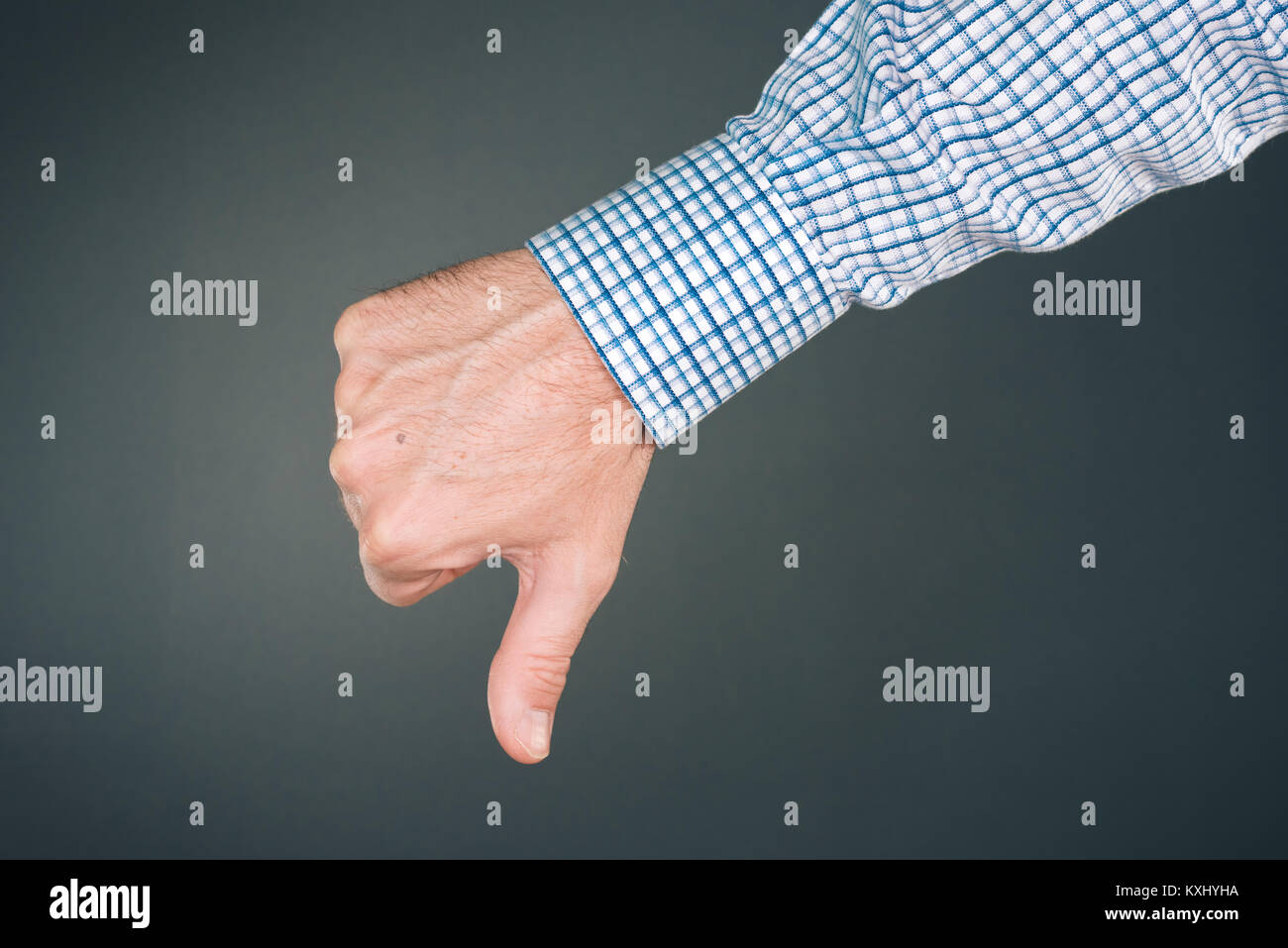 Dislike and disapprove hand gesture with thumb down, businessman is rejecting project Stock Photo